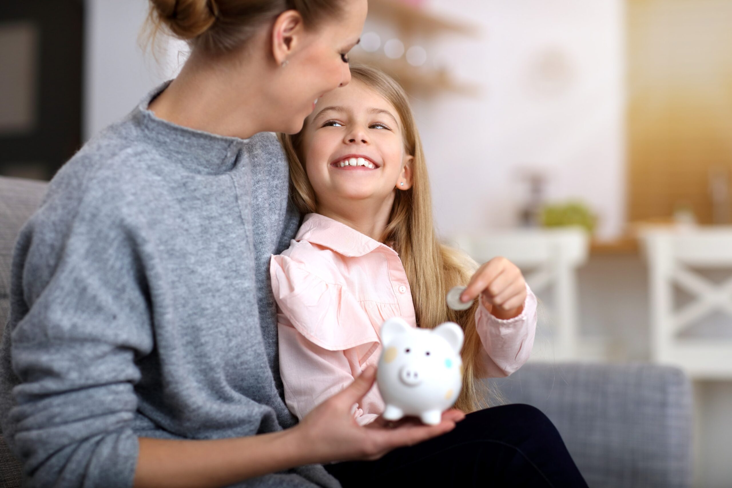 Young girl and her mother with piggybank thinking about her SMSF setup